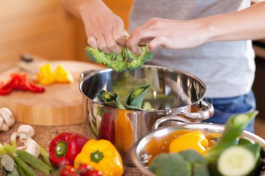 Woman preparing stew clipart