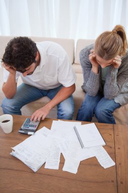 Portrait of a young couple doing their accounting clipart