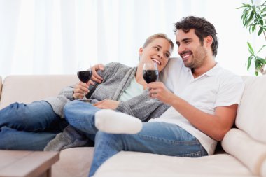 Couple drinking a glass of red wine clipart