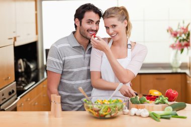 Young couple slicing pepper clipart