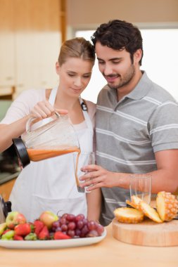 Portrait of a couple drinking fruits juice clipart