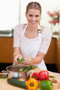 Portrait of a smiling woman cooking clipart