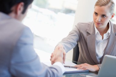 Serious manager interviewing a male applicant clipart