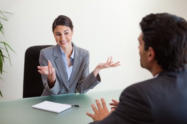 Smiling manager interviewing an employee clipart