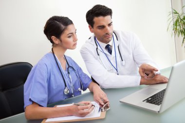 Doctors working with a notebook clipart