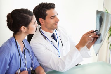 Young doctors looking at a set of X-ray clipart