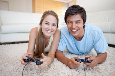 Smiling couple playing video games clipart