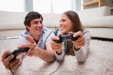 Happy couple playing video games together clipart