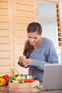 Woman spicing her meal clipart