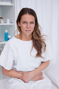 Woman having bad stomachache clipart