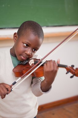 Portrait of a schoolboy playing the violin clipart