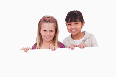 Girls behind a blank panel clipart