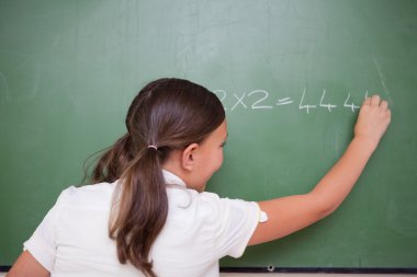 Schoolgirl writing numbers clipart
