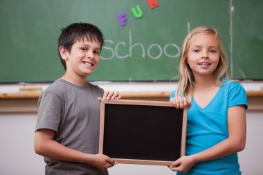 Pupils holding a school slate clipart