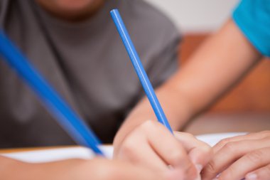 Close up of two arms holding pens clipart