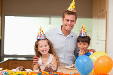 Father celebrating birthday with his kids clipart