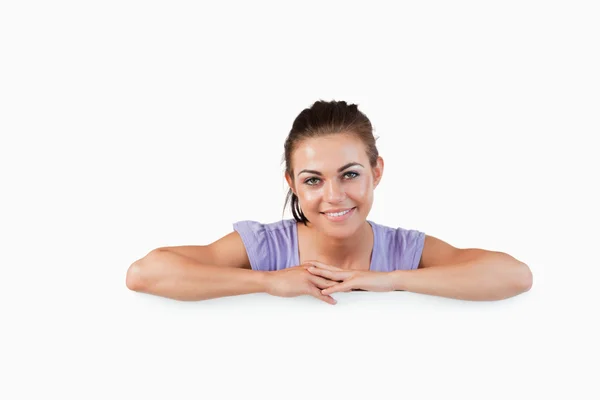 Smiling young female with banner below her — Stock Photo, Image
