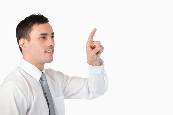 Businessman pointing at invisible screen — Stock Photo, Image