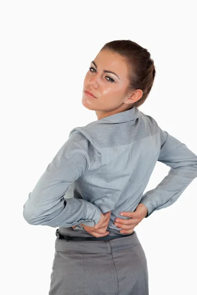 Portrait of a tired businesswoman having back pain — Stock Photo, Image