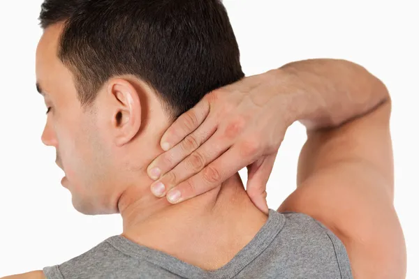 Young male massaging his back — Stock Photo, Image
