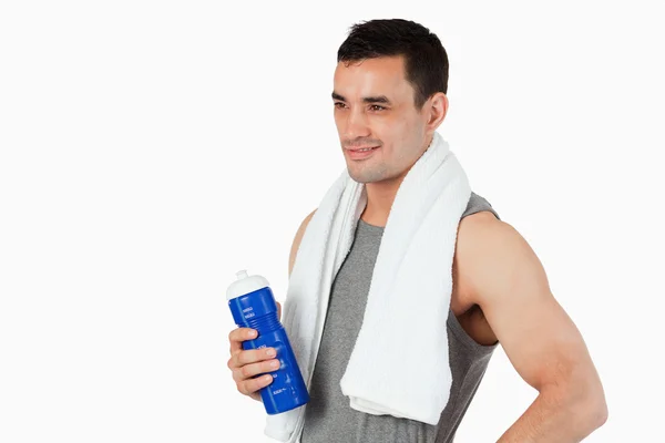 Young man with a bottle after workout — Stock Photo, Image