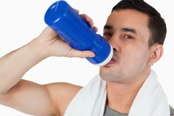 Close up of young man drinking water after workout — Stock Photo, Image