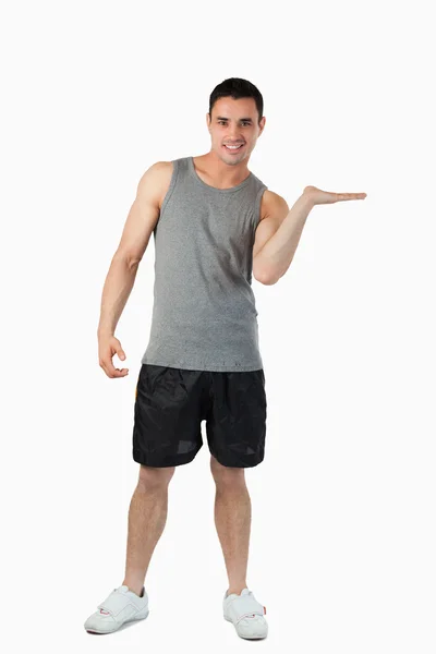 Male in sports cloths presenting — Stock Photo, Image