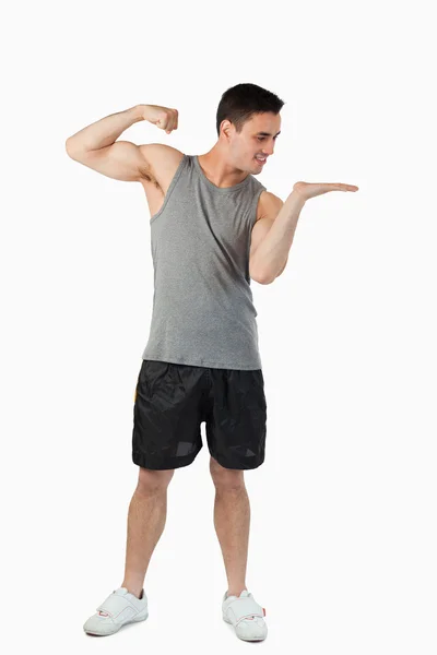Young male about to punch what he is presenting — Stock Photo, Image