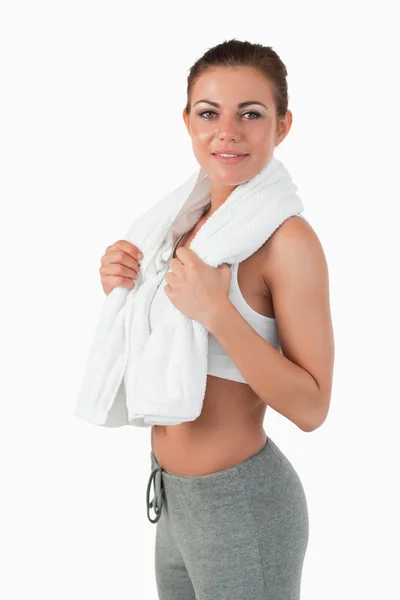 Side view of sportswoman with towel around her neck — Stock Photo, Image