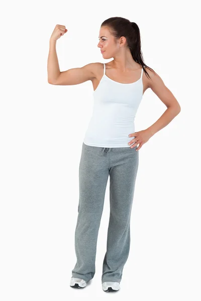Jovem mulher mostrando seu bíceps — Fotografia de Stock
