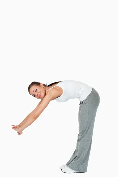 Atletic female doing her stretches — Stock Photo, Image