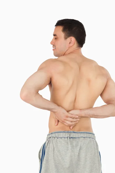 Молодой мужчина испытывает боли в спине — стоковое фото