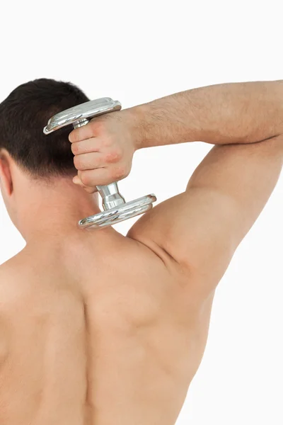 Back view of young man with dumbbell — Stock Photo, Image