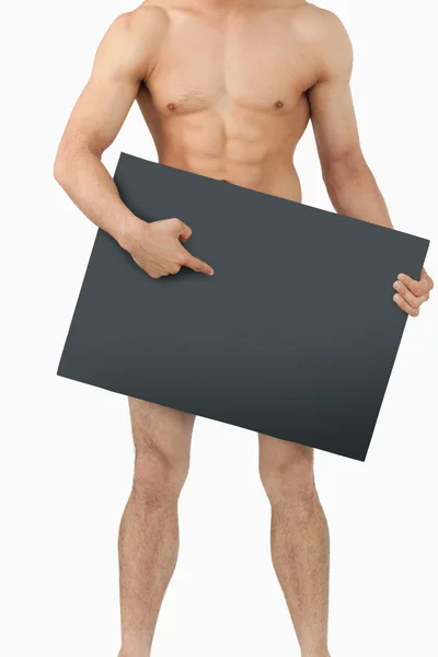 Cuerpo masculino atlético apuntando a la pancarta debajo de él — Foto de Stock