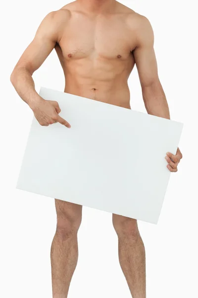 Well shaped male body pointing on banner below him — Stock Photo, Image