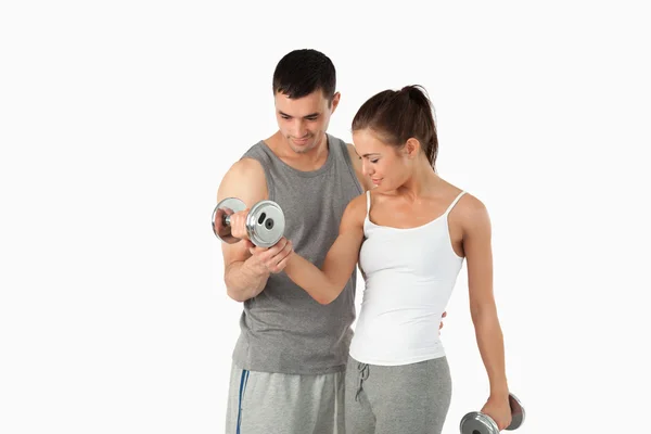 Man helping a woman to work out — Stock Photo, Image