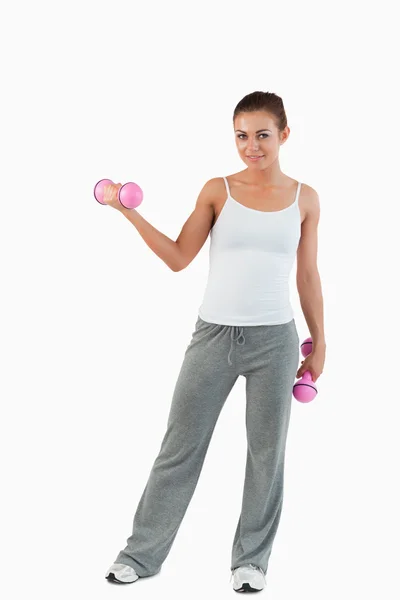 Portrait of a fit woman working out with dumbbells — Stock Photo, Image
