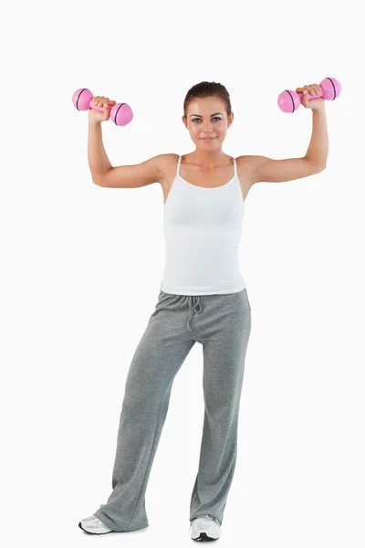 Portrait of a young woman working out with dumbbells — Stock Photo, Image