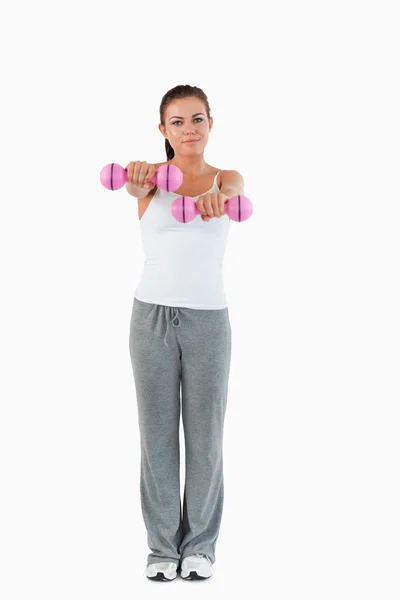 Portrait of a cute woman working out with dumbbells — Stock Photo, Image
