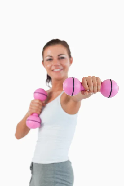 Portrait of a happy woman working out with dumbbells — Stock Photo, Image