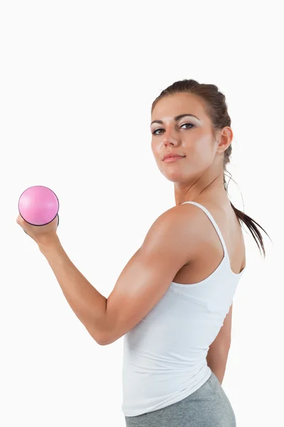Portrait of a brunette woman working out with dumbbells — Stock Photo, Image