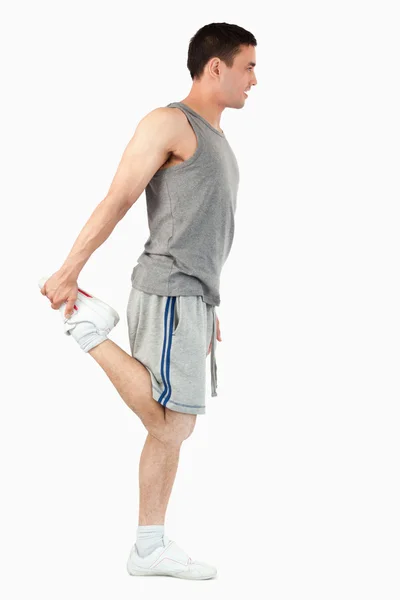 Retrato de um desportista a esticar a perna — Fotografia de Stock