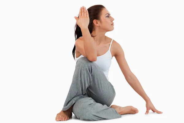 Portrait of a fit woman in the Ardha Matsyendrasana position — Stock Photo, Image