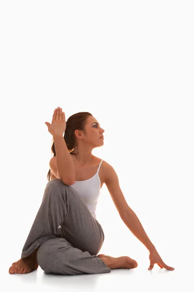 Portrait of a young woman in the Ardha Matsyendrasana position — Stock Photo, Image