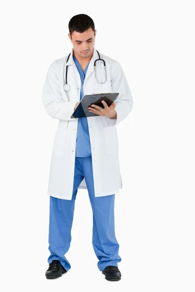 Portrait of a doctor writing on a clipboard — Stock Photo, Image