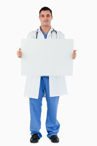 Portrait of a doctor holding a blank panel — Stock Photo, Image
