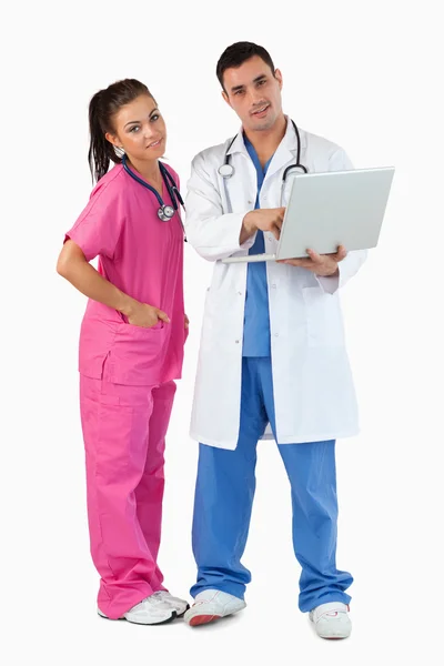 Portrait of doctors using a laptop — Stok fotoğraf