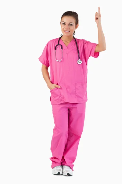 Portrait of a female doctor pointing at a copy space — Stock Photo, Image