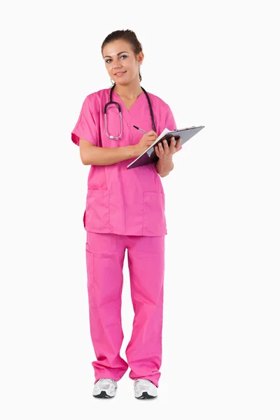 Portrait of a female doctor taking notes — Stockfoto