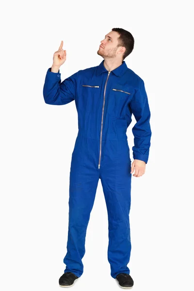 Young mechanic in boiler suit pointing up — Stock Photo, Image